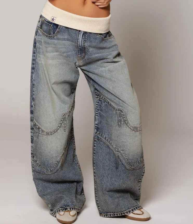 Stylish women's Y2K baggy wide leg jeans, offering an oversized fit and a distinctive ribbed waistband.