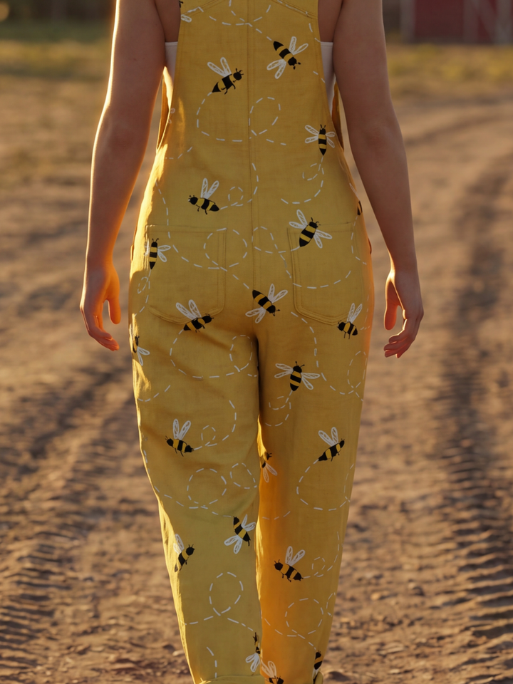 Whimsical women's honeybee print jumpsuit. Yellow, relaxed fit with wide straps & straight leg for effortless summer fashion.