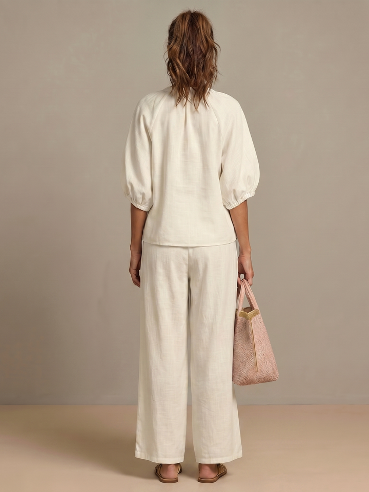 Women's zip-up blouson top and relaxed wide-leg pants. Matching set for casual or travel.