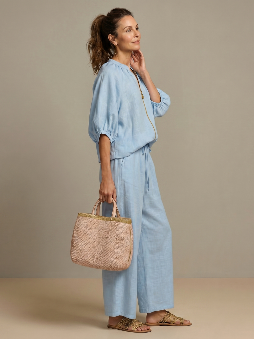 Relaxed fit women's two-piece set with a zip blouson top and comfortable wide leg pants.