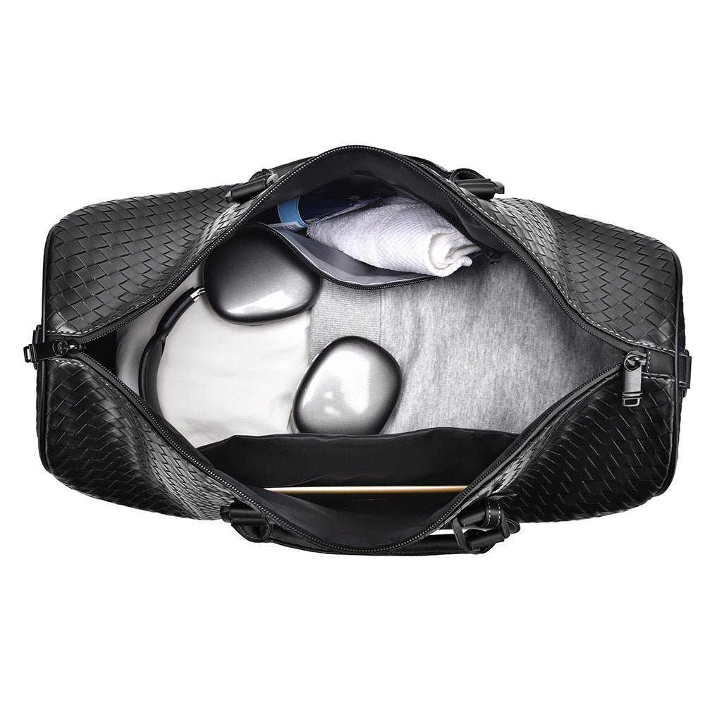 Elegant woven leather duffle bag, spacious for travel essentials & stylish weekend adventures.